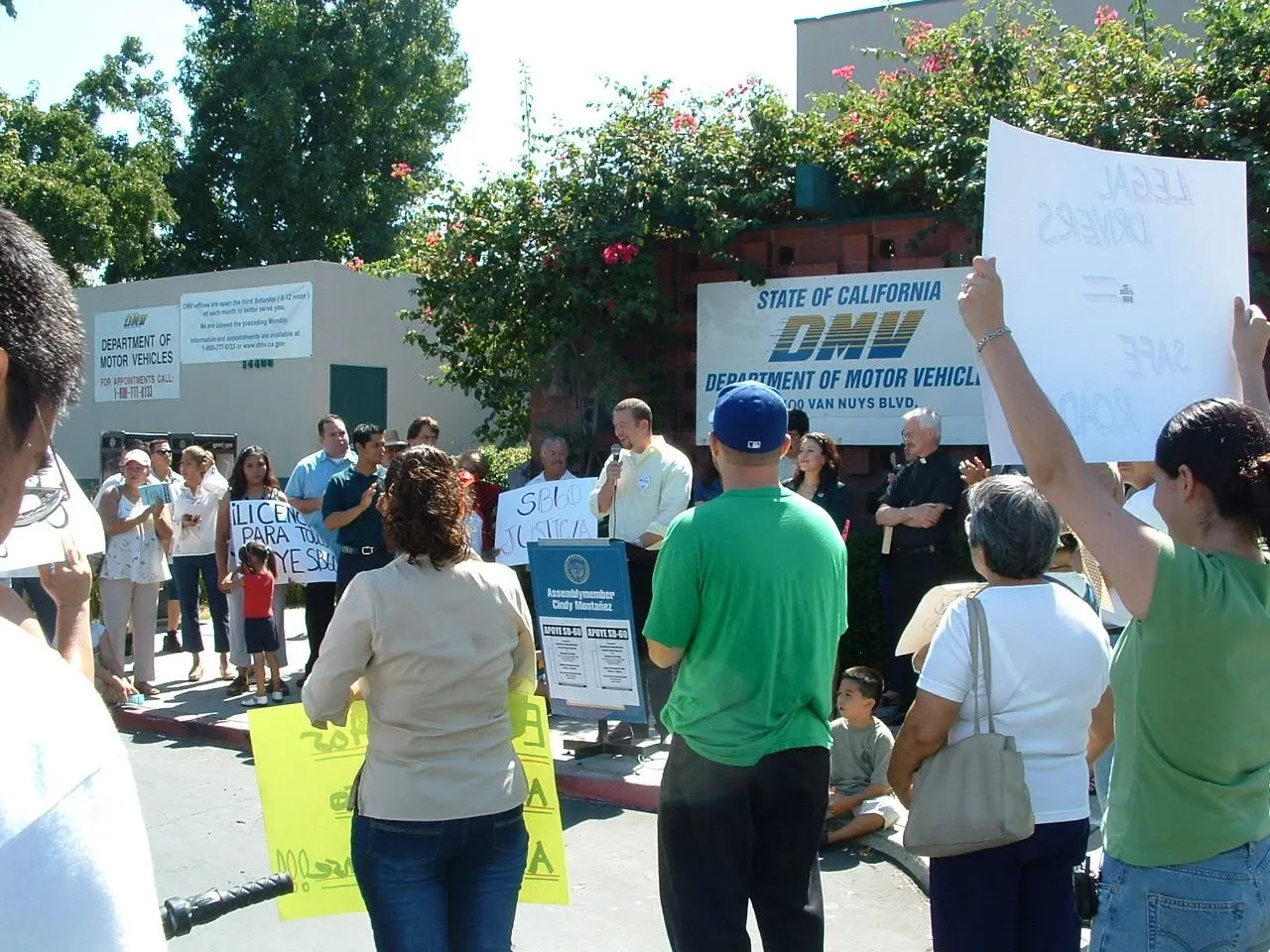 Community members rallying at the DMV for driver’s licenses