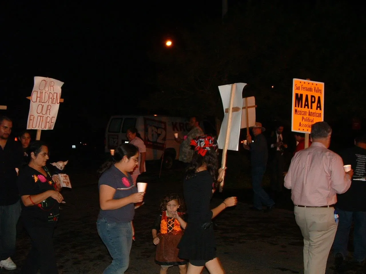 Supporters holding a MAPA sign at a community rally